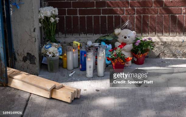 Small memorial is placed at the door of a Bronx day care center as police and crime scene investigators continue work, after a 1-year-old child died...