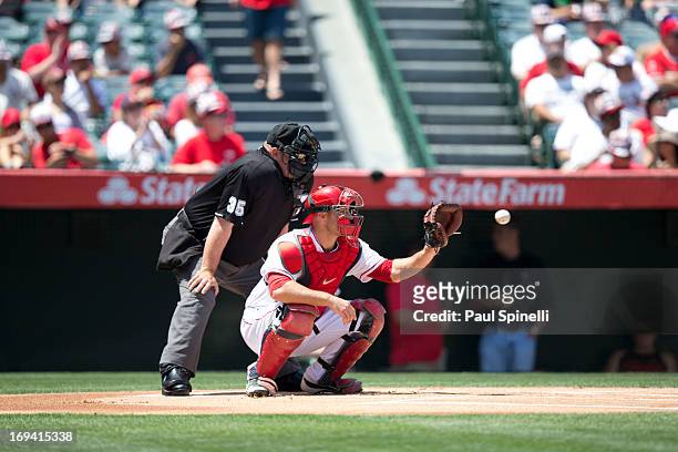 Chris Iannetta of the Los Angeles Angels of Anaheim catches as home plate umpire Wally Bell calls balls and strikes during the game against the...