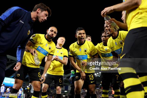 Orbelin Pineda of AEK Athens talks to teammates whilst in a huddle prior to the UEFA Europa League 2023/24 group stage match between Brighton & Hove...