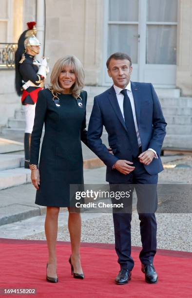 French President Emmanuel Macron and his wife Brigitte Macron pose after their meeting with Queen Camilla and King Charles III at the Elysee...