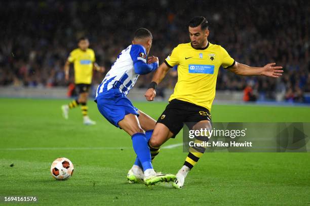 Ehsan Hajsafi of AEK Athens clashes with Joao Pedro of Brighton & Hove Albion during the UEFA Europa League 2023/24 group stage match between...