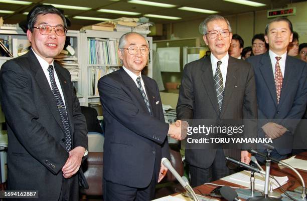 Keiu Nishida , president of Mitsui Trust and Banking Co. Ltd., shakes hands with Shozo Endo , president of Chuo Trust and Banking Co. Ltd., after a...
