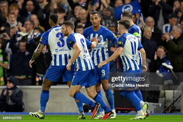 Joao Pedro of Brighton & Hove Albion celebrates with teammates after scoring a penalty during the UEFA Europa League 2023/24 group stage match...