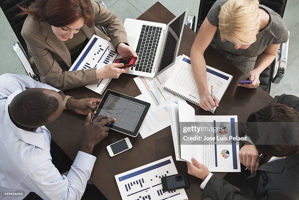 Business people meeting using tablets and phones