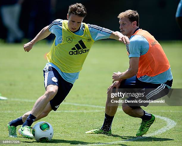 Nicolai Mueller is challenged by Benedikt Hoewedes during a training session at Barry University on May 24, 2013 in Miami, Florida.