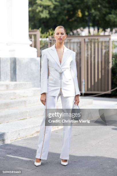 Karolina Kurkova wears white tailored blazer, pants, bag, pointed heels outside Genny during the Milan Fashion Week - Womenswear Spring/Summer 2024...