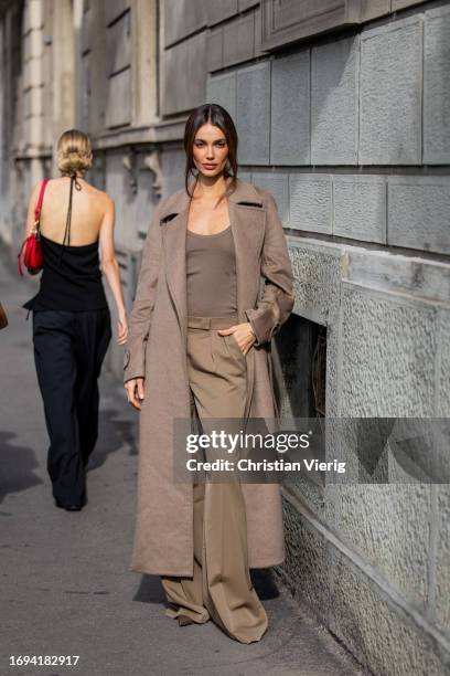 Mari Fonseca wears brown coat, wide leg pants, shirt outside Max Mara during the Milan Fashion Week - Womenswear Spring/Summer 2024 on September 21,...