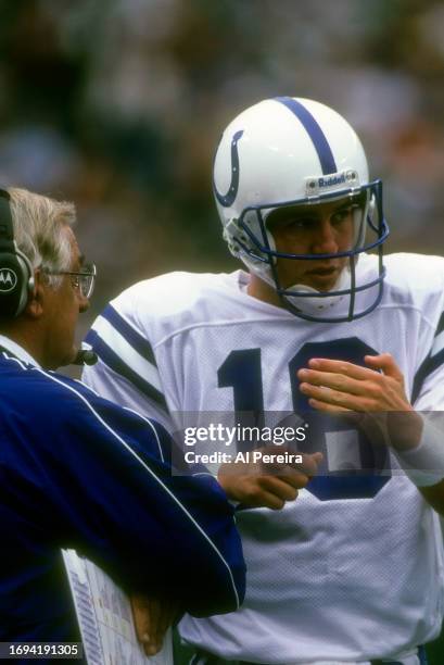 Quarterback Peyton Manning of the Indianapolis Colts speaks with Head Coach Jim Mora in the game between the Indianapolis Colts vs the New York Jets...