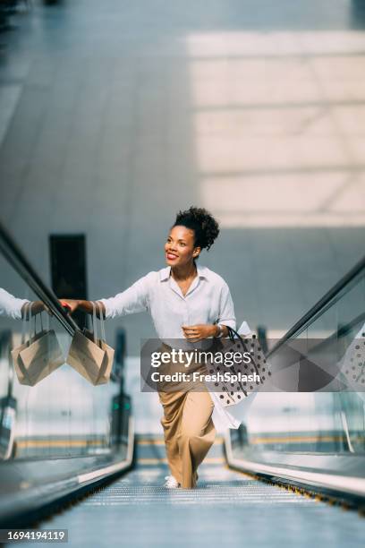 una hermosa mujer cubana feliz mirando hacia otro lado mientras va de compras - centro comercial fotografías e imágenes de stock