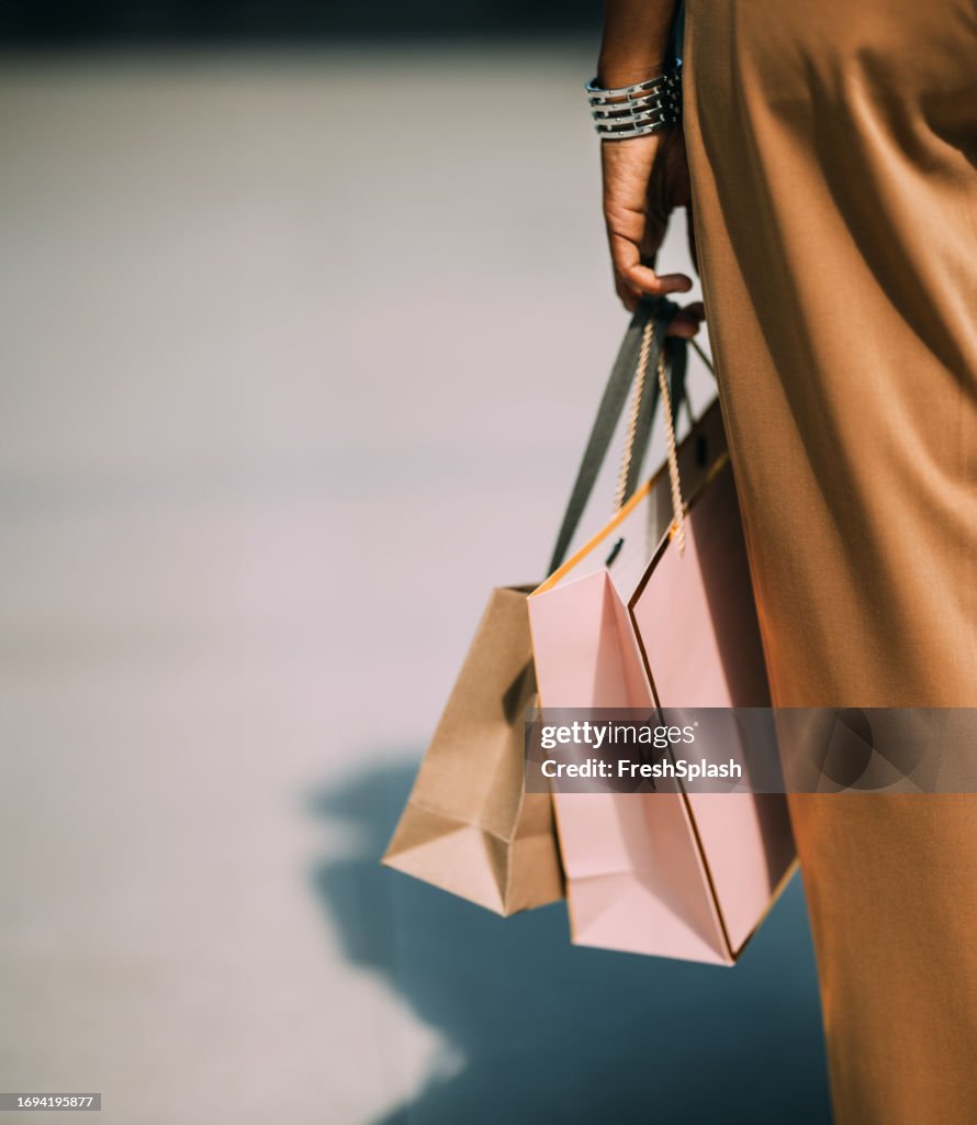 A Close Up View Of An Unrecognizable Beautiful Cuban Woman Holding Paper Bags After Going Shopping