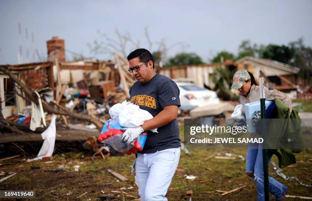 Volunteers bring blankets, water and other relief goods for a tornado victim in Moore, Oklahoma, on May 24, 2013. The tornado, one of the most...