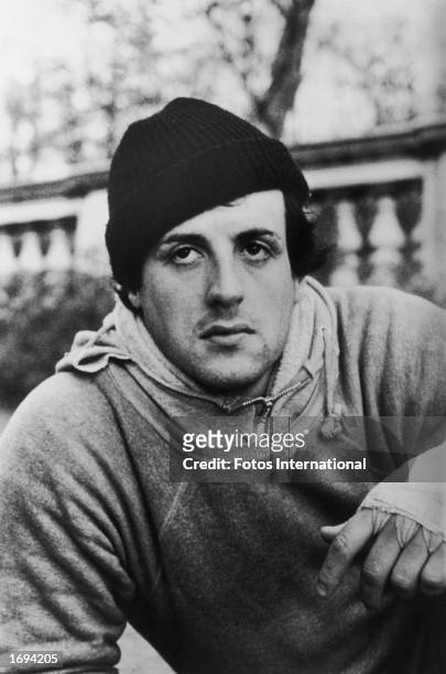 American actor Sylvester Stallone wears a knit hat, sweatshirts and bandages around his fists in a still from the film, 'Rocky,' directed by John G....