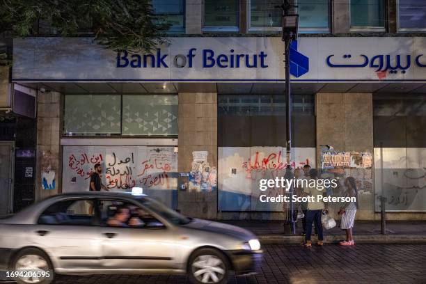 Graffiti painted on the side of a Bank of Beirut building, in the upscale Hama neighborhood, warns that it is the headquarters of thieves and...