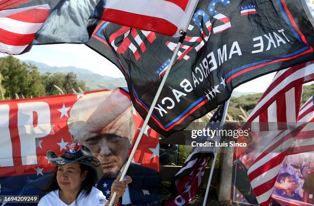 Simi Valley, CA - A woman who declined to be identified shows support for former president Donald Trump as GOP presidential candidates debated...