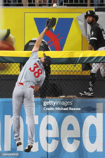 Matt Wallner of the Minnesota Twins can't catch a two-run home run hit by Andrew Vaughn of the Chicago White Sox during the seventh inning at...