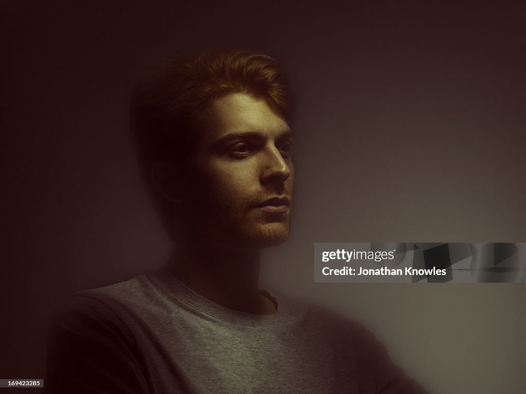 Light painted portrait of red hair male, side view