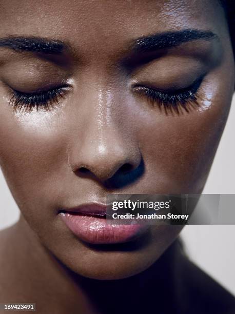 close up of black females face with closed eyes - wimper stockfoto's en -beelden