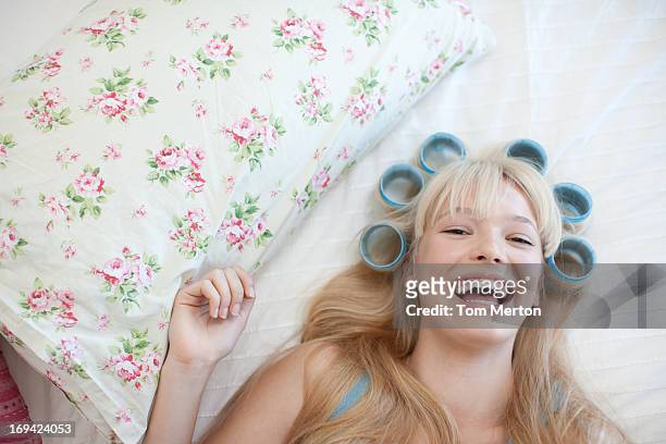 woman laying with curlers in hair - papiljott bildbanksfoton och bilder