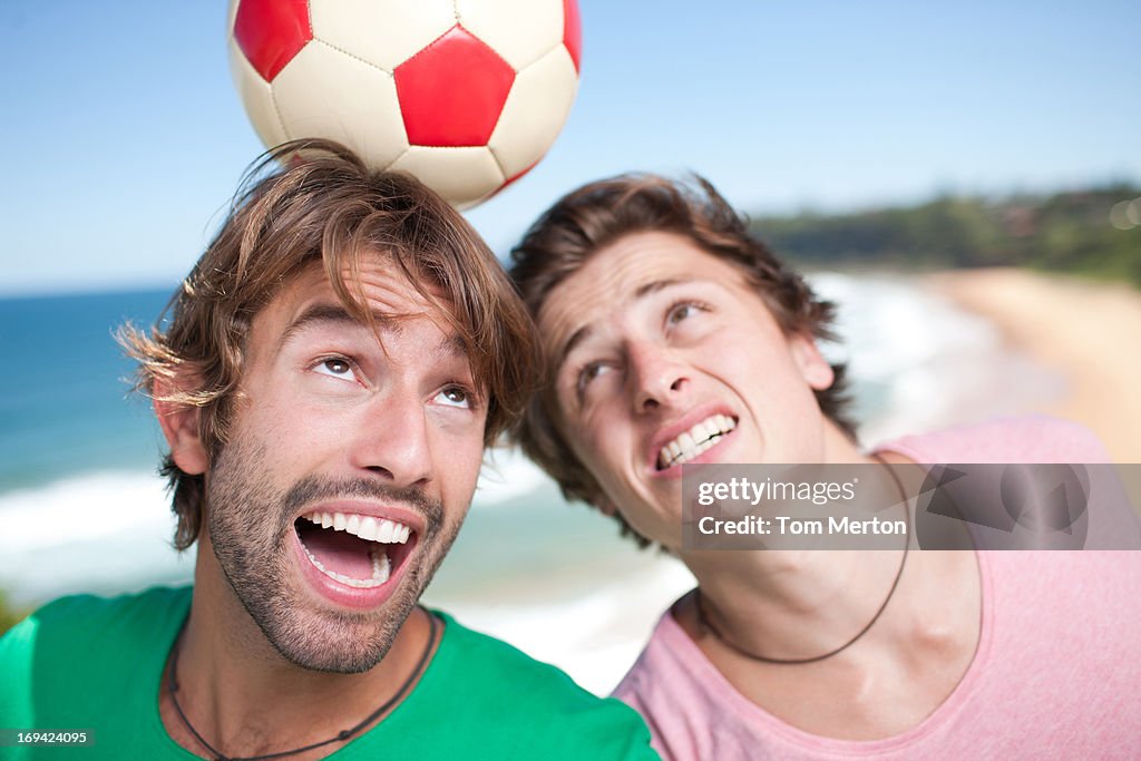 Men playing soccer beach