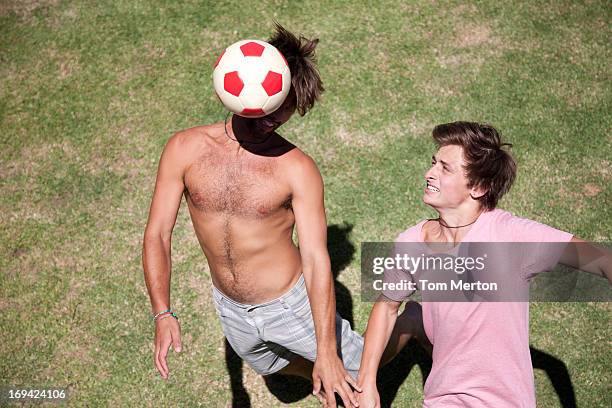 men playing soccer on grass - barefeet soccer stock pictures, royalty-free photos & images