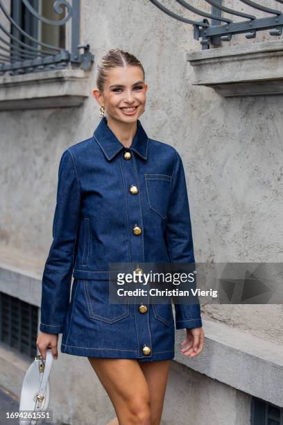 Xenia Adonts wears denim jacket, skirt, white bag outside Prada during the Milan Fashion Week - Womenswear Spring/Summer 2024 on September 21, 2023...