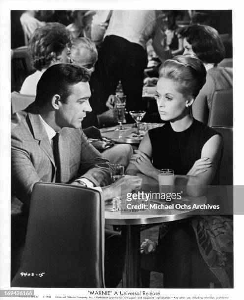 Sean Connery and Tippi Hedren having drinks in a scene from the film 'Marnie', 1964.
