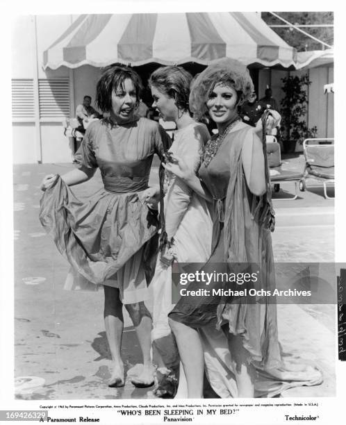 Carol Burnett, Elizabeth Montgomery, and Jill St John posing in Edith Head costumes in between scenes from the film 'Who's Been Sleeping In My Bed?',...