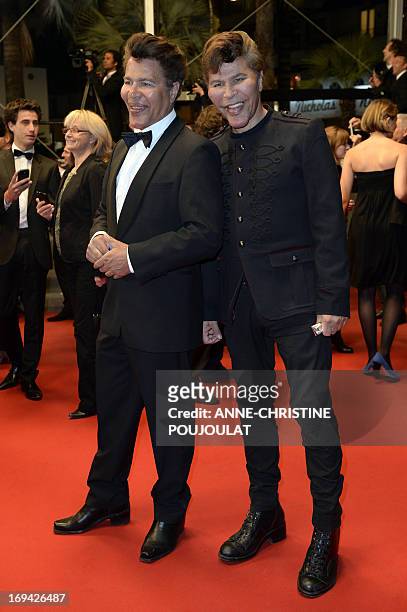 French scientific journalists Igor et Grichka Bogdanoff pose on May 24, 2013 as they arrive for the screening of the film "Michael Kohlhaas"...
