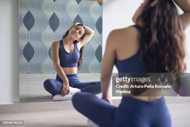 woman stretching her head and neck - human neck stock pictures, royalty-free photos & images