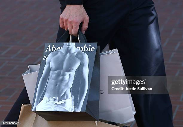 Pedestrian carries an Abercrombie and Fitch shopping bag on May 24, 2013 in San Francisco, California. Teen apparel retailer Abercrombie and Fitch...