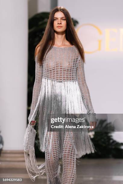 Genny Model A model walks the runway at the Genny fashion show during the Milan ...