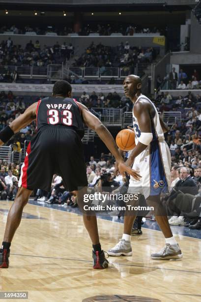 Guard Michael Jordan of the Washington Wizards looks to play the ball as guard Scottie Pippen of the Portland Trail Blazers defends during the game...