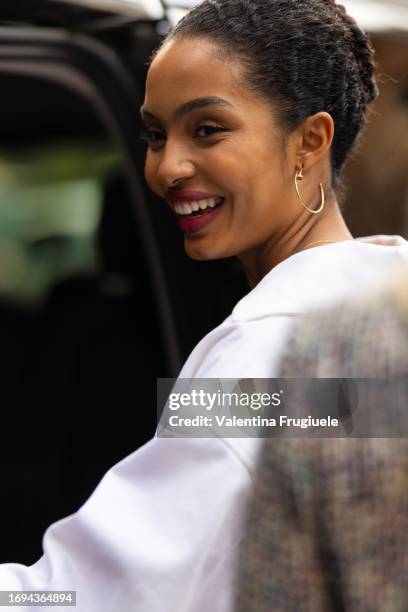 Yara Shahidi is seen wearing Cartier hoop gold earrings and a white over-sized jacket outside the Max Mara show during the Milan Fashion Week -...