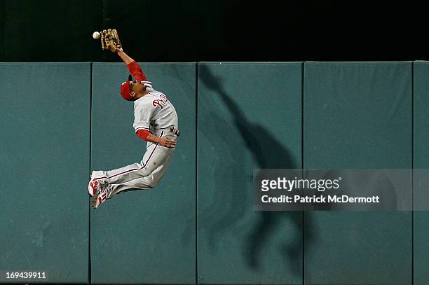 Ben Revere of the Philadelphia Phillies fails to catch a RBI triple hit by Adam LaRoche of the Washington Nationals in the fifth inning during a game...