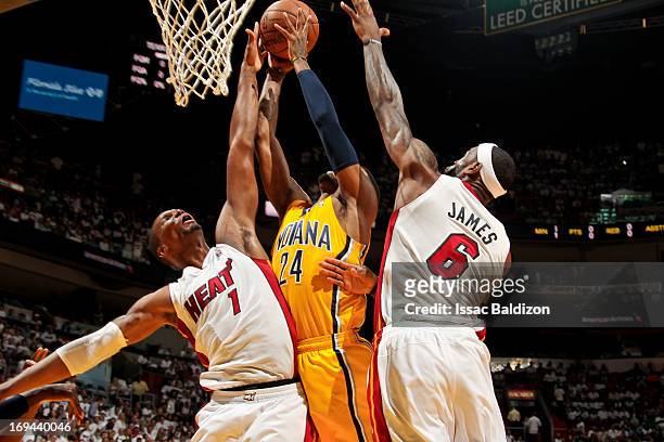 Chris Bosh and LeBron James of the Miami Heat contest a shot attempt by Paul George of the Indiana Pacers in Game Two of the Eastern Conference...