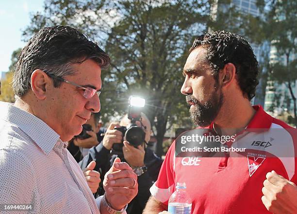 Adam Goodes of the Sydney Swans speaks with AFL CEO Andrew Demetriou after speaking to the media during an AFL press conference on May 25, 2013 in...