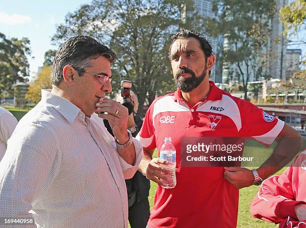 Adam Goodes of the Sydney Swans speaks with AFL CEO Andrew Demetriou after speaking to the media during an AFL press conference on May 25, 2013 in...