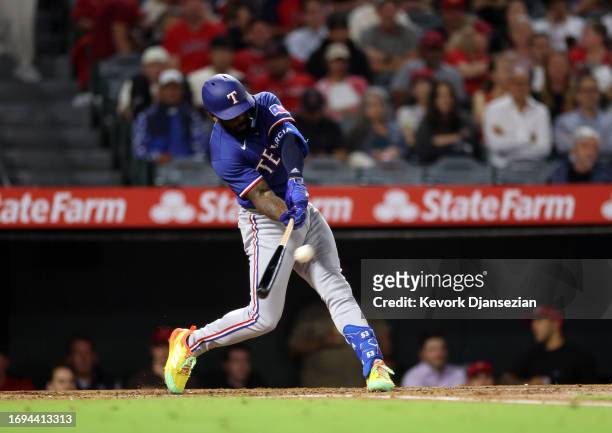 Adolis Garcia of the Texas Rangers hits a one-run home run during the third inning against pitcher Griffin Canning of the Los Angeles Angels at Angel...
