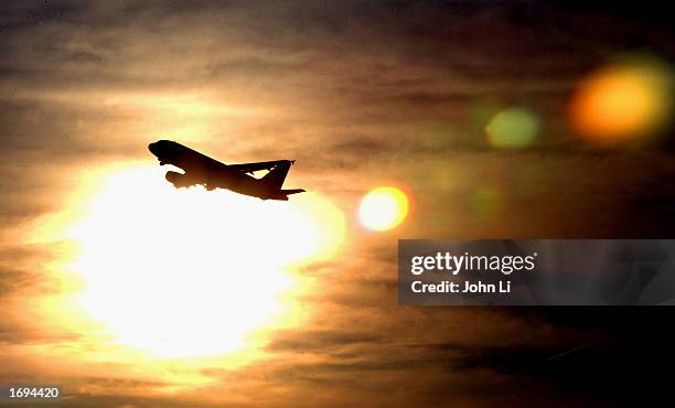 Plane is silhouetted against the sky as it takes off from Heathrow Airport December 19, 2002 in London, England. The British Government announced...
