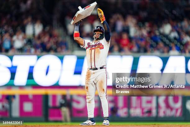 Ronald Acuña Jr. #13 of the Atlanta Braves celebrates after stealing second base in the tenth inning against the Chicago Cubs at Truist Park on...