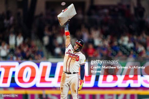 Ronald Acuña Jr. #13 of the Atlanta Braves celebrates after stealing second base in the tenth inning against the Chicago Cubs at Truist Park on...