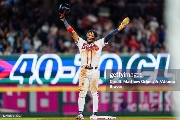 Ronald Acuña Jr. #13 of the Atlanta Braves celebrates after stealing second base in the tenth inning against the Chicago Cubs at Truist Park on...