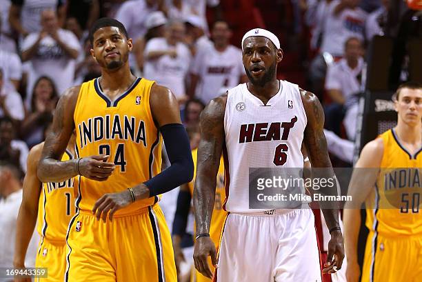 LeBron James of the Miami Heat talks to Paul George of the Indiana Pacers after making a three point basket to end the third quarter during Game Two...
