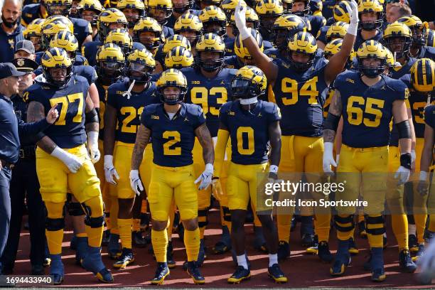 Michigan Wolverines players get ready to run onto the field before a college football game against the Rutgers Scarlet Knights on September 2023 at...