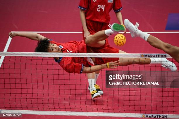 Thailand's Manlika Bunthod kicks the ball in the semifinal of the women's team sepak takraw match during the Hangzhou 2022 Asian Games, in Jinhua, in...