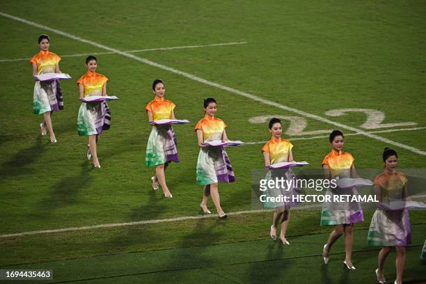 This photo taken on September 26, 2023 shows Hostesses taking part in the medal ceremony for the Rugby Seven event of the Hangzhou 2022 Asian Games...