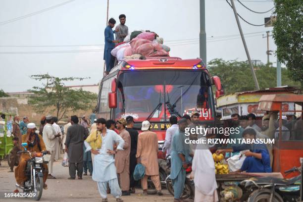 In this photo taken on September 21 Afghan refugees board a bus from Karachi to Afghanistan. Afghans have poured into Pakistan in their millions...