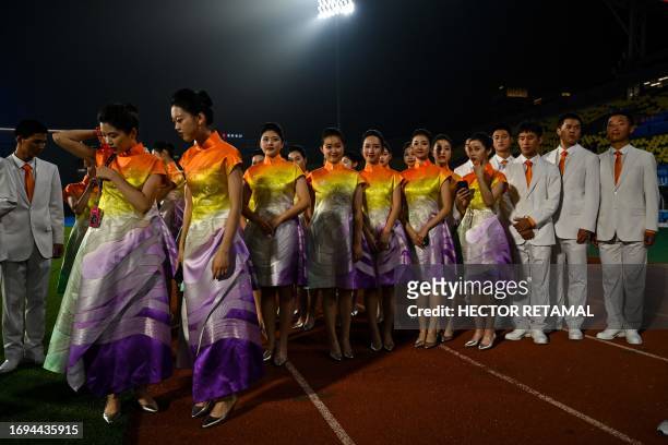 This photo taken on September 26, 2023 shows hostesses after taking part in the medal ceremony for the Rugby Seven event of the Hangzhou 2022 Asian...