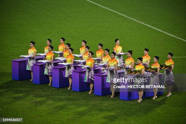This photo taken on September 26, 2023 shows Hostesses taking part in the medal ceremony for the Rugby Seven event of the Hangzhou 2022 Asian Games...