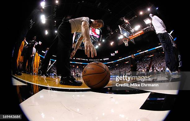 An official reaches to pick up the ball during Game Two of the Eastern Conference Finals between the Indiana Pacers and the Miami Heat at...